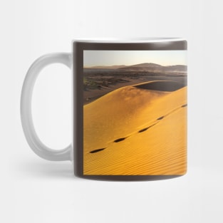 Footsteps in the sand. Mug